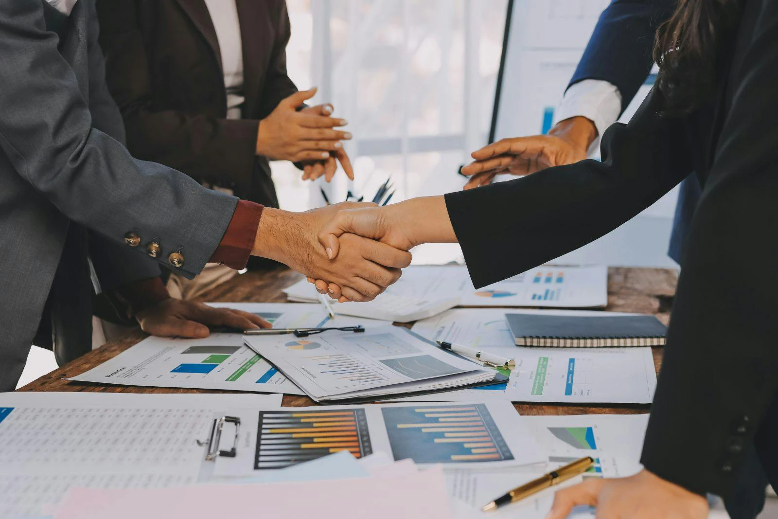 Business handshake for teamwork of business merger and acquisition,successful negotiate,hand shake,two businessman shake hand with partner to celebration partnership and business deal concept