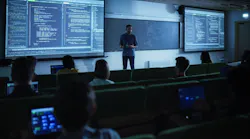 Young Male Teacher Giving a Data Science Lecture to Students in Dark College Room. Projecting Slideshow with Artificial Intelligence Architecture