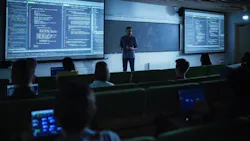 Young Male Teacher Giving a Data Science Lecture to Students in Dark College Room. Projecting Slideshow with Artificial Intelligence Architecture Young Male Teacher Giving a Data Science Lecture to Students in Dark College Room. Projecting Slideshow with Artificial Intelligence Architecture