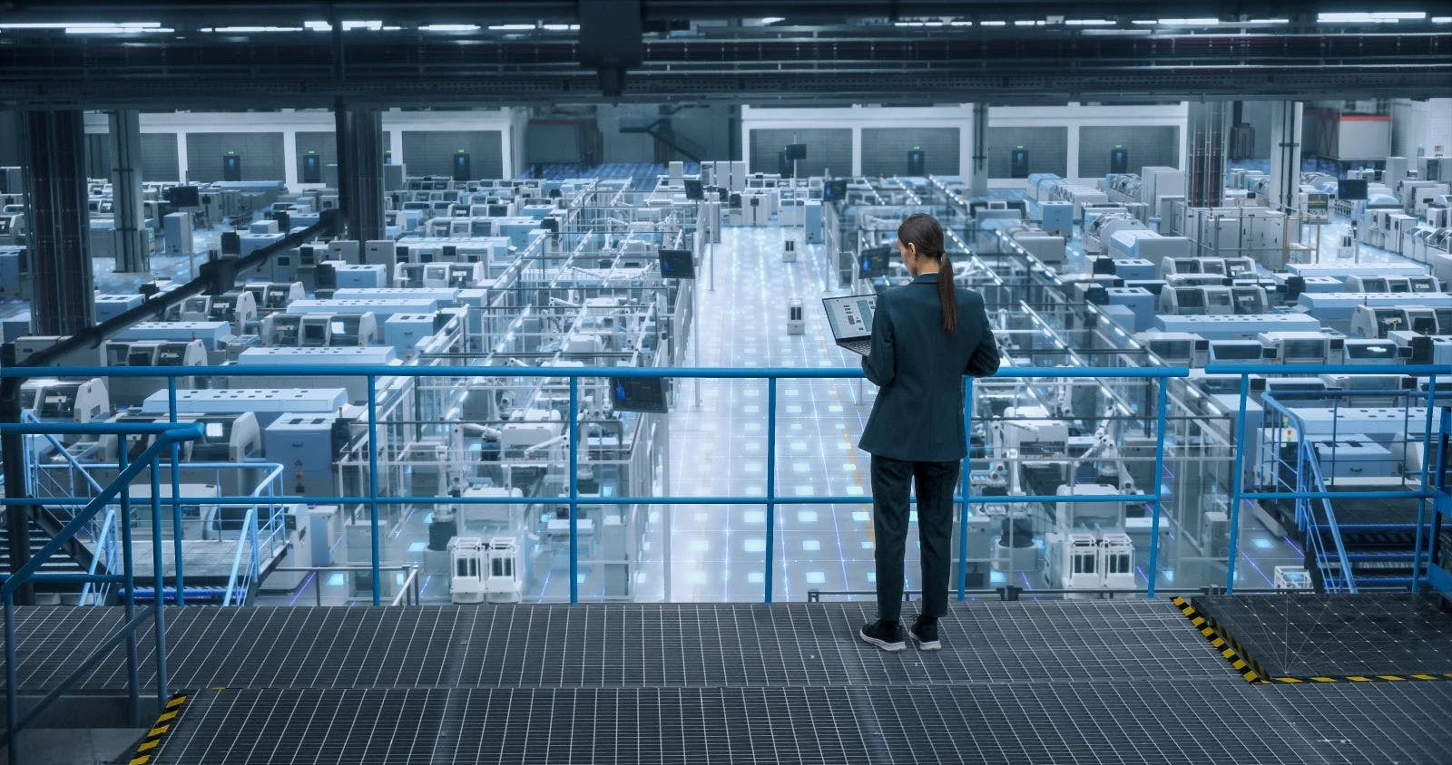 Female Engineer Uses Laptop to Activate Construction of Autonomous Robot Arm Industrial Facility.