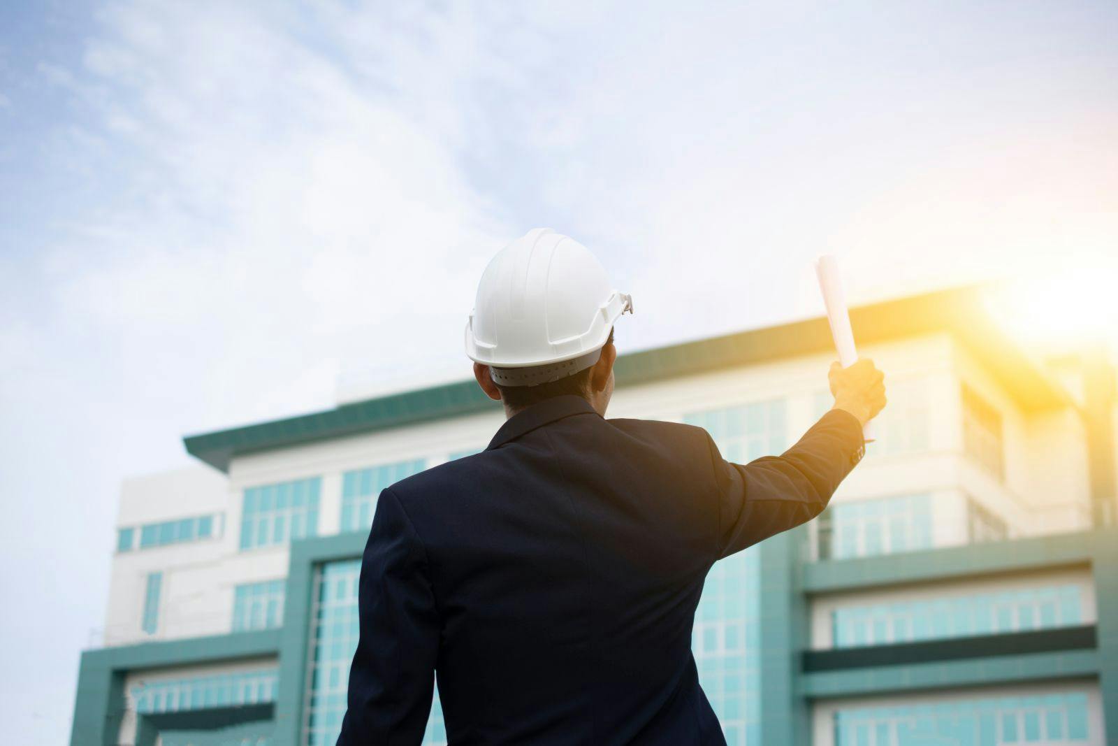 Engineer Holding paper plan and building Sky Background