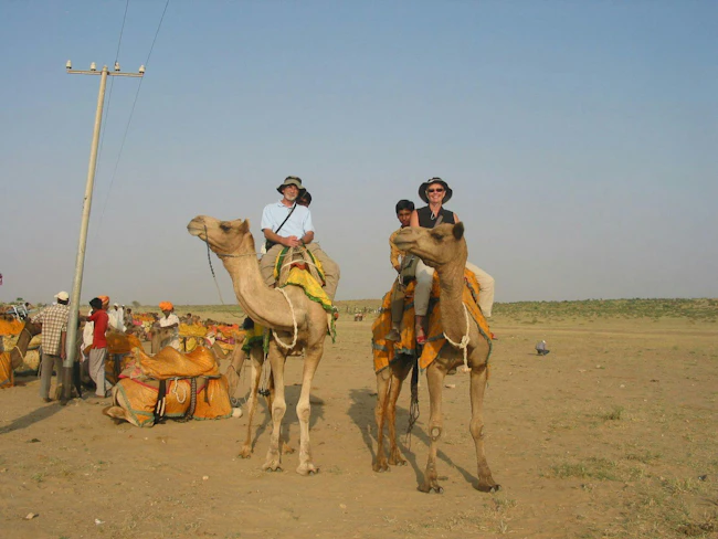 Peter Morgan riding a camel in India in 2006