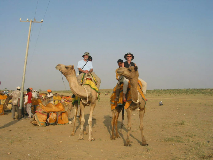 Peter Morgan riding a camel in India in 2006