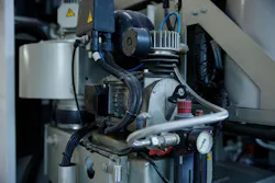 A detailed close up of a compressor machine featuring two gauges situated on it A detailed close up of a compressor machine featuring two gauges situated on it