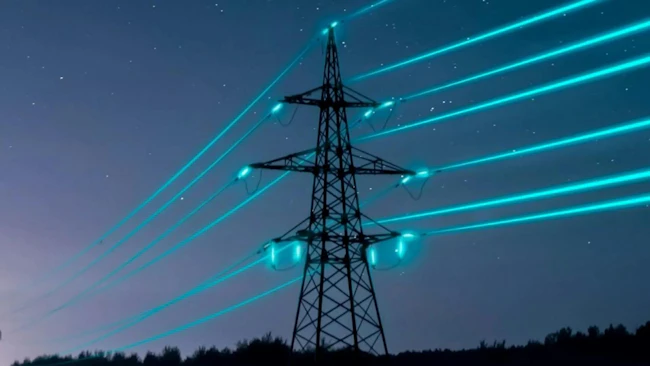 A grid tower on a twilight sky with bright blue energy passing through