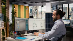 Sustainability RD expert uses CAD program on PC to design production lines for solar panel assembly.