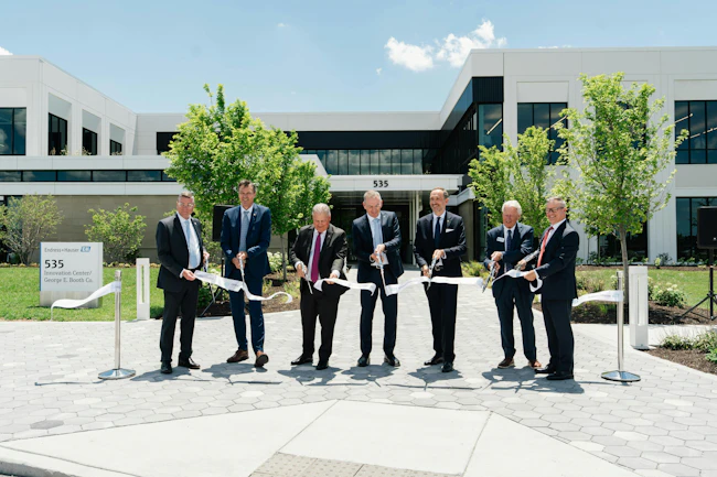 Wielding the traditional, big, shiny scissors, ribbon cutters inaugurating Endress+Hauser USA Innovation Center and new George E. Booth headquarters on June 23 include (l. to r.) Mark Myers, mayor of Greenwood, Ind., Laurent Malley, chief sales officer at Endress+Hauser, Todd Lucey, managing director at Endress+Hauser USA, Peter Selders, CEO at Endress+Hauser, Steven Endress, president of Endress+Hauser&rsquo;s Supervisory Board, George E. Booth II, and Scott Young, president of George E. Booth.