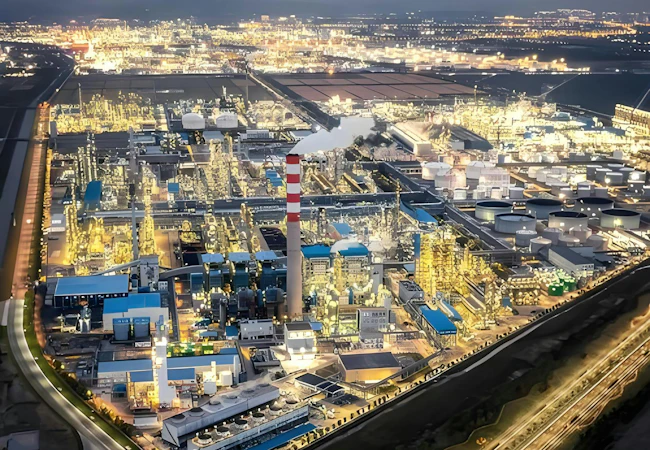 Aerial view of Zhejiang Petroleum & Chemical facility and the surrounding urban cityscape.