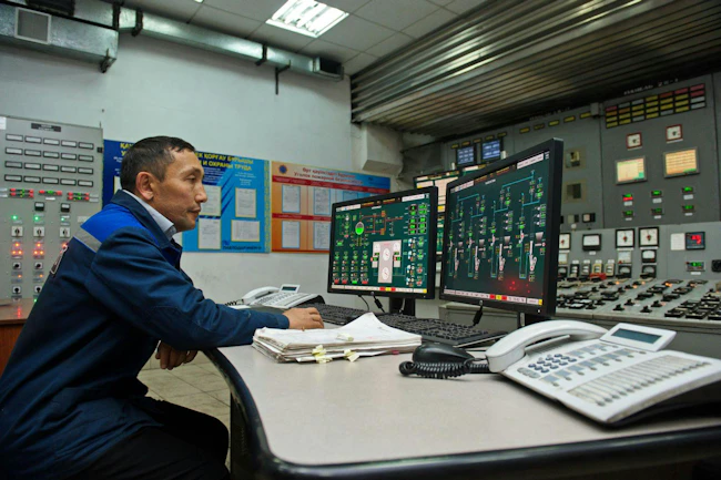 Engineers monitor the indicators in the central control point of the thermal power plant