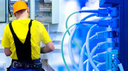Energy consumption system in the office. The electrician mounts the shield and lays the wires. Installation of the electricity supply system. Block for connecting devices to the electrical network.