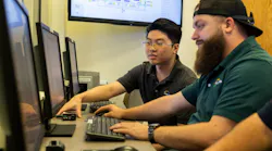 Two Process and Data Automation employees working together on computers