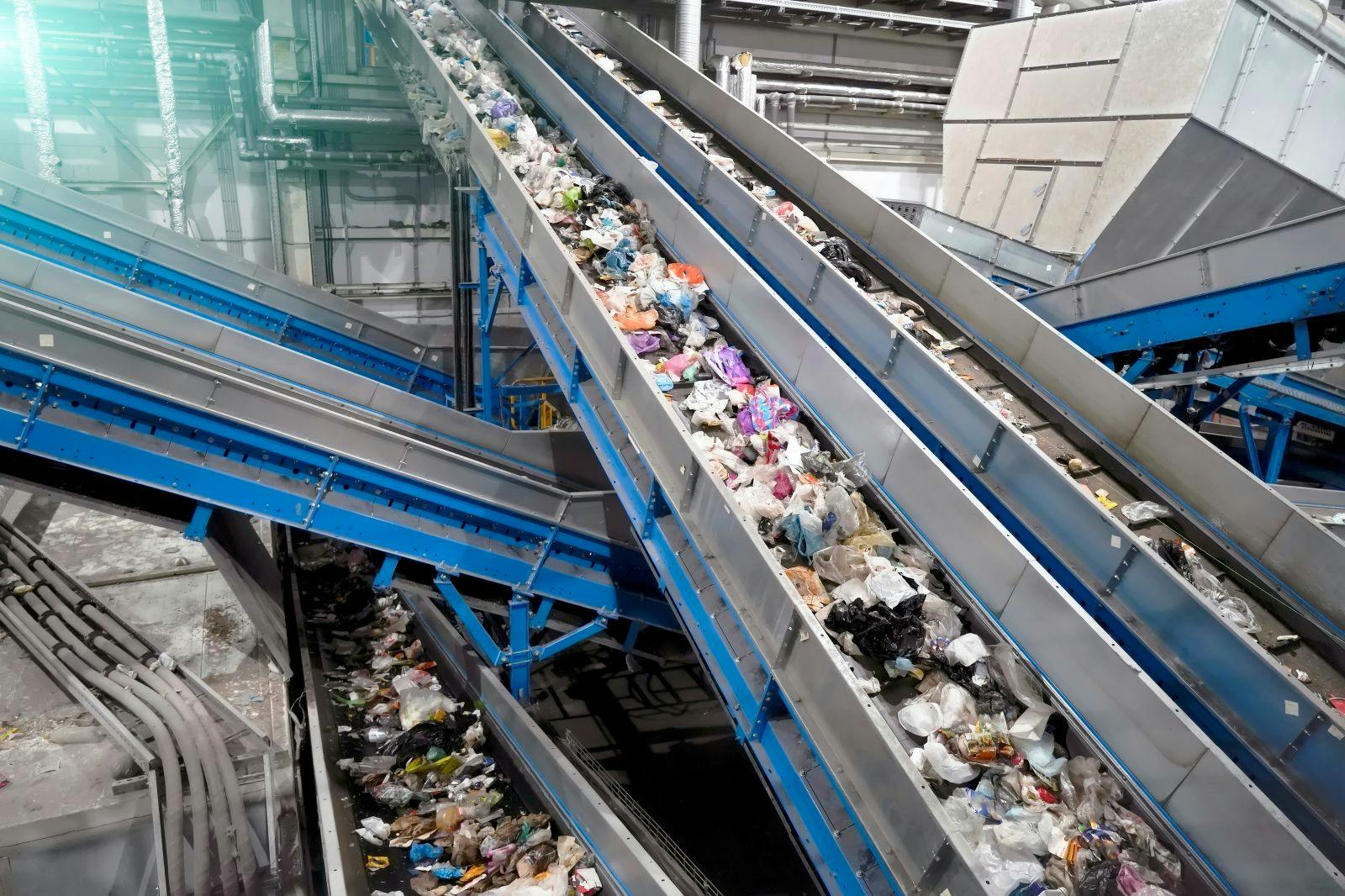 Conveyor lines for waste sorting and processing at a waste collection plant.