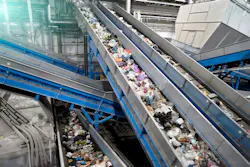 Conveyor lines for waste sorting and processing at a waste collection plant.