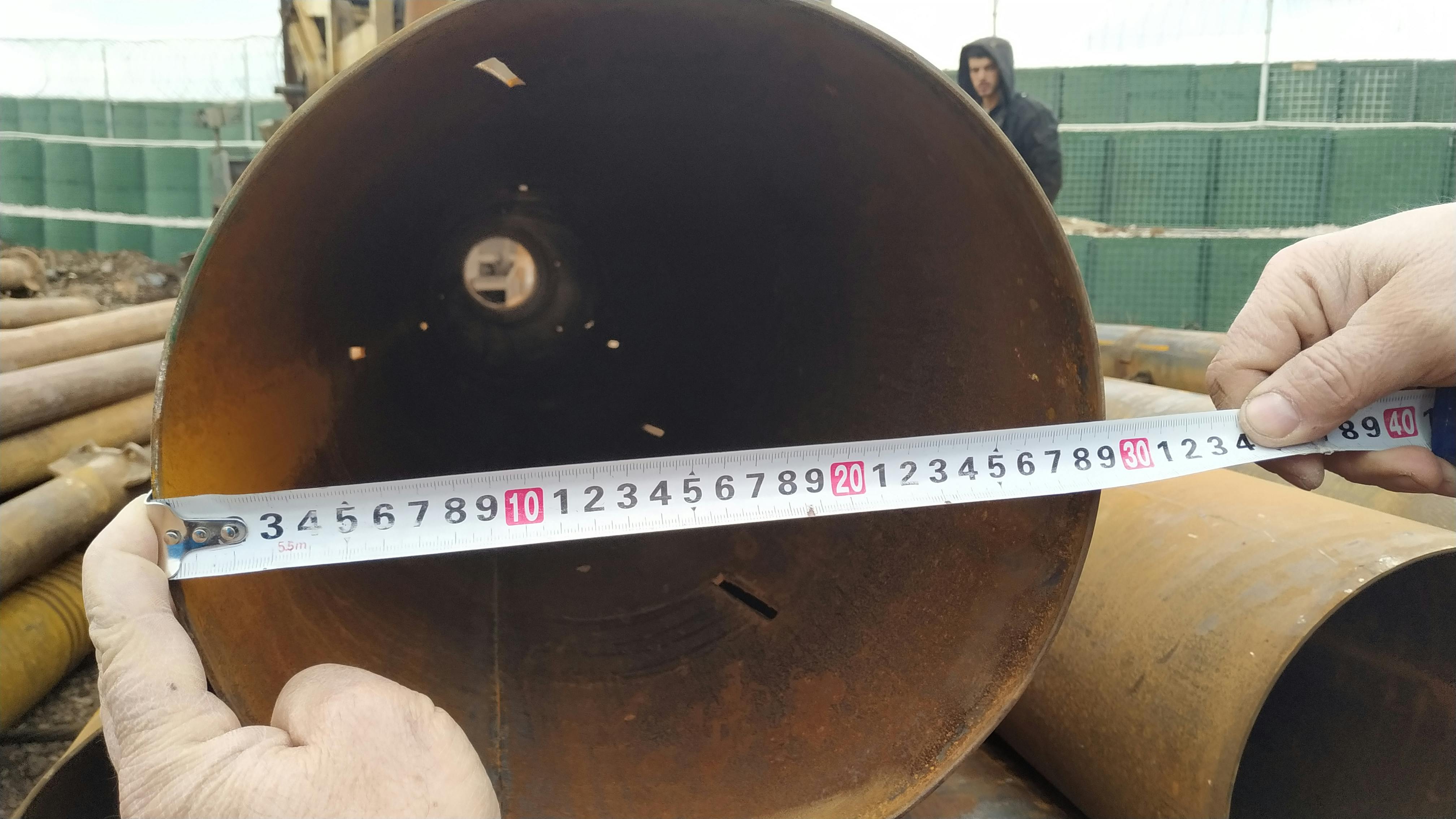Measurements are being conducted on a pipe for making sure the size is accurate