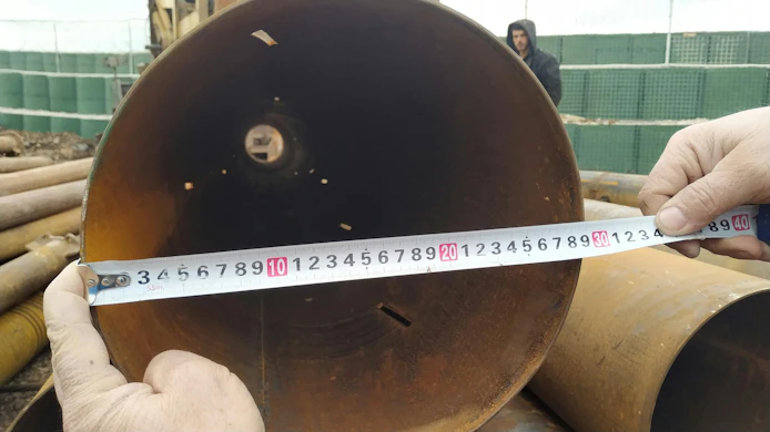Measurements are being conducted on a pipe for making sure the size is accurate