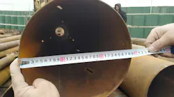 Measurements are being conducted on a pipe for making sure the size is accurate