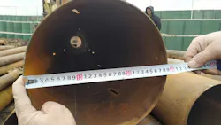 Measurements are being conducted on a pipe for making sure the size is accurate