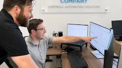 Dylan Lane, digital manufacturing systems manager (standing), and Gotzon Mugica, lead control systems engineer III (seated), review code for an upcoming project at George T. Hall, a system integrator in Anaheim, Calif.