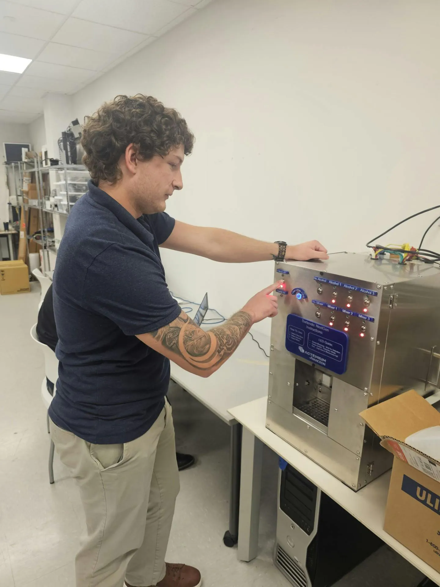 Figure 2: Wade Kaminski, staff engineer at Actemium-Avanceon and recent graduate from Penn State Berks, demonstrates the Bartendo automated drink system and senior capstone project they developed during Actemium-Avanceon's partnership with Penn State Berks University in Reading, Pa.