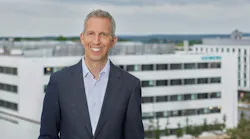 Rainer Brehm headshot in front of a skyline