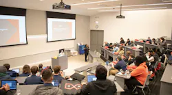 Figure 1: Visiting students attend a classroom demonstration at MxD in Chicago, which works to strengthen U.S. manufacturing by advancing technology adoption, cyber readiness and building a strong workforce.
