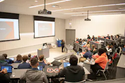 Figure 1: Visiting students attend a classroom demonstration at MxD in Chicago, which works to strengthen U.S. manufacturing by advancing technology adoption, cyber readiness and building a strong workforce.