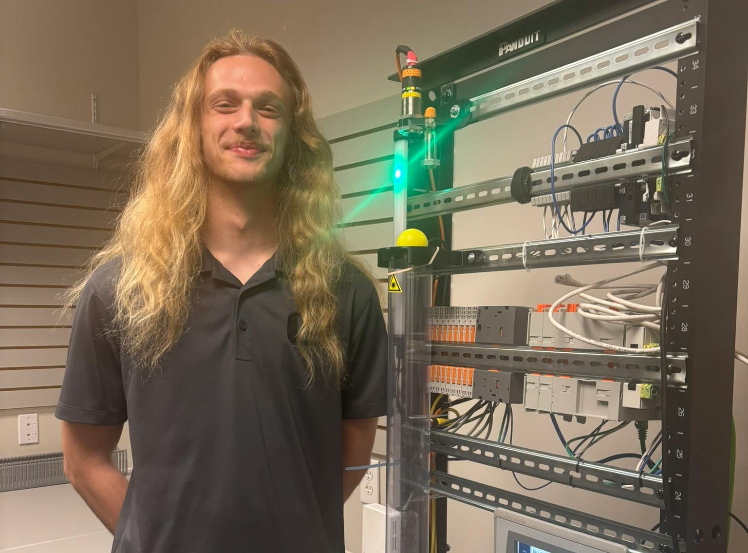 Figure 1: Jackson Prine, Next engineer at Eosys, demonstrates its proportional, integral, derivative (PID) trainer.
