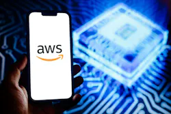 Amazon Web Services logo on a smartphone against the background a blue glowing AI chip