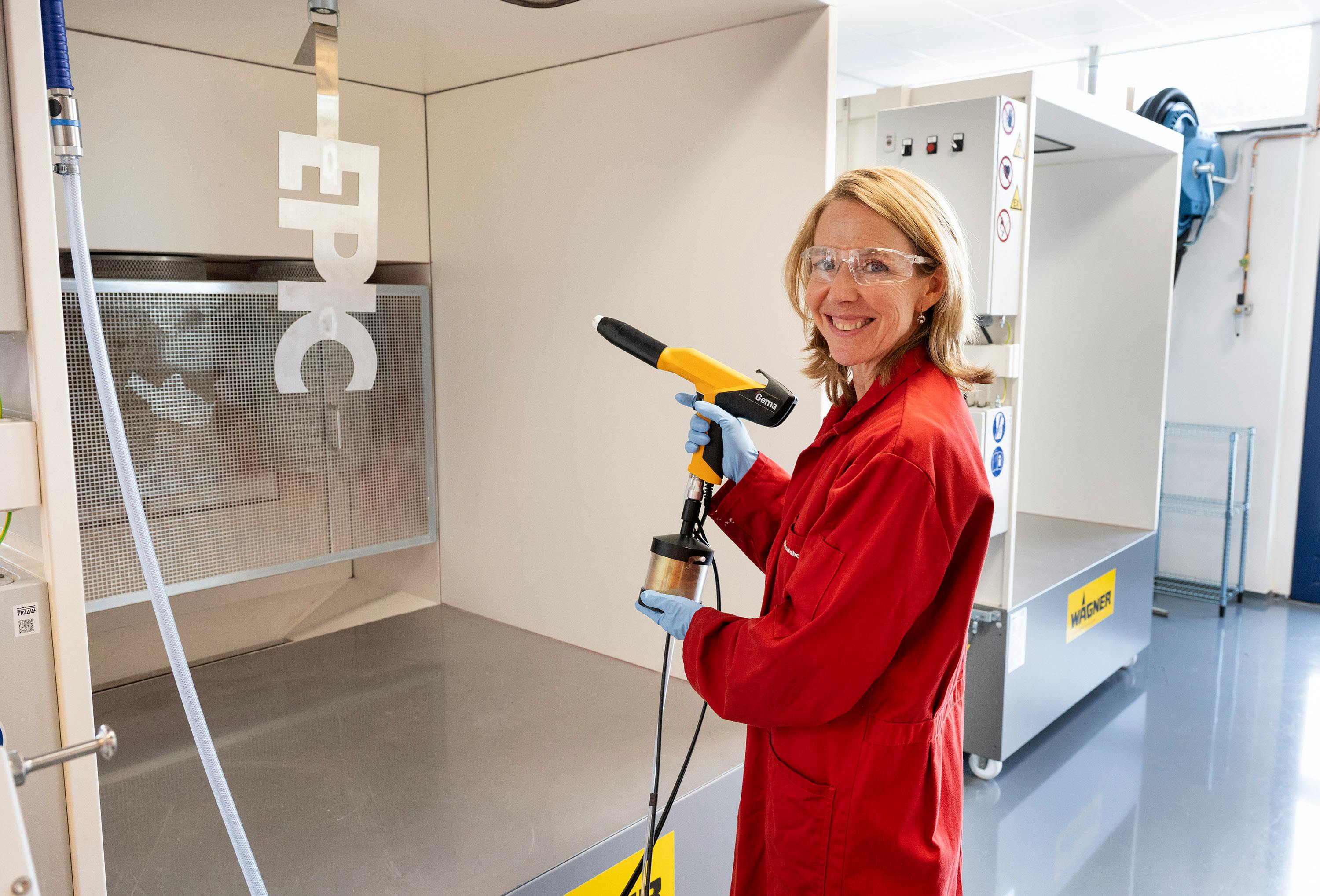 Stientje van Veldhoven, Dutch minister of climate and green growth, tries a paint gun at AkzoNobel&rsquo;s powder coatings innovation lab in Sassenheim.