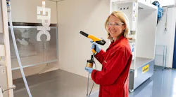 Stientje van Veldhoven, Dutch minister of climate and green growth, tries a paint gun at AkzoNobel’s powder coatings innovation lab in Sassenheim.