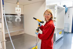 Stientje van Veldhoven, Dutch minister of climate and green growth, tries a paint gun at AkzoNobel’s powder coatings innovation lab in Sassenheim.