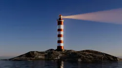 A night lighthouse with a bright beam of light illuminating the dark sea waves.