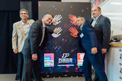Four officials from Purdue, Rittal and Eplan placing their hands on a wall promoting their new engineering lab