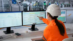 Woman At Factory Screens Checks Production Data For Efficient Workflow Management