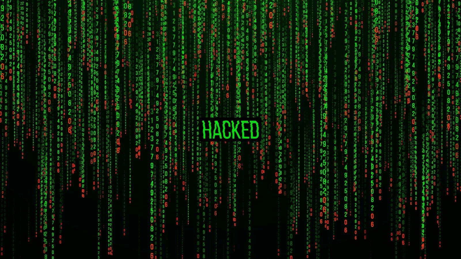 Matrix background with the green symbols with the word HACKED in the center written in bright green